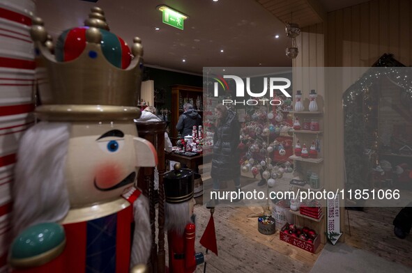 Several people look at decorations at a Christmas market in the town of Akureyri, Iceland, on November 30, 2024. Christmas in Iceland, known...