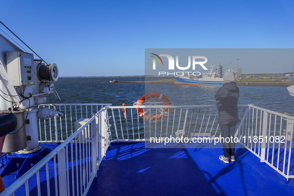 A woman looks at the Esbjerg port from the electric ferry in Nordby, Fano Island, Denmark, on April 29, 2024. 