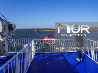 A woman looks at the Esbjerg port from the electric ferry in Nordby, Fano Island, Denmark, on April 29, 2024. (