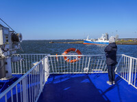 A woman looks at the Esbjerg port from the electric ferry in Nordby, Fano Island, Denmark, on April 29, 2024. (