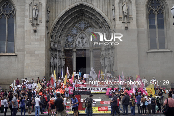 People hold crosses during a demonstration in downtown Sao Paulo, Brazil, on December 9, 2024, to protest against police violence following...