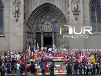 People hold crosses during a demonstration in downtown Sao Paulo, Brazil, on December 9, 2024, to protest against police violence following...