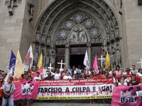 People hold crosses during a demonstration in downtown Sao Paulo, Brazil, on December 9, 2024, to protest against police violence following...