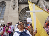 People hold crosses during a demonstration in downtown Sao Paulo, Brazil, on December 9, 2024, to protest against police violence following...