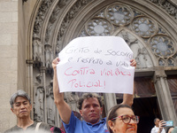 People hold crosses during a demonstration in downtown Sao Paulo, Brazil, on December 9, 2024, to protest against police violence following...