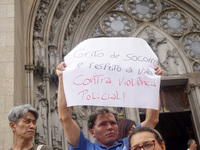 People hold crosses during a demonstration in downtown Sao Paulo, Brazil, on December 9, 2024, to protest against police violence following...