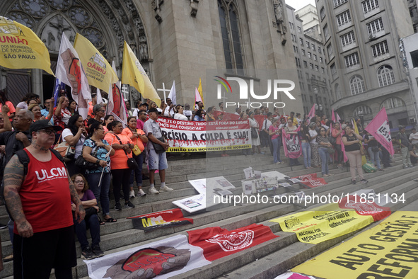 People hold crosses during a demonstration in downtown Sao Paulo, Brazil, on December 9, 2024, to protest against police violence following...