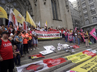 People hold crosses during a demonstration in downtown Sao Paulo, Brazil, on December 9, 2024, to protest against police violence following...