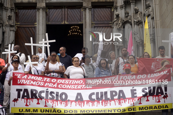 People hold crosses during a demonstration in downtown Sao Paulo, Brazil, on December 9, 2024, to protest against police violence following...