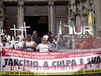 People hold crosses during a demonstration in downtown Sao Paulo, Brazil, on December 9, 2024, to protest against police violence following...