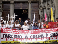 People hold crosses during a demonstration in downtown Sao Paulo, Brazil, on December 9, 2024, to protest against police violence following...