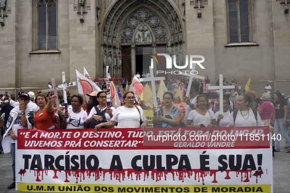 People hold crosses during a demonstration in downtown Sao Paulo, Brazil, on December 9, 2024, to protest against police violence following...