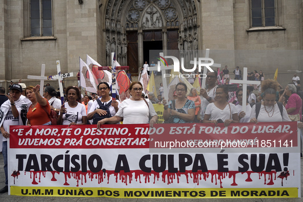 People hold crosses during a demonstration in downtown Sao Paulo, Brazil, on December 9, 2024, to protest against police violence following...