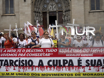 People hold crosses during a demonstration in downtown Sao Paulo, Brazil, on December 9, 2024, to protest against police violence following...