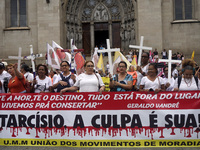 People hold crosses during a demonstration in downtown Sao Paulo, Brazil, on December 9, 2024, to protest against police violence following...