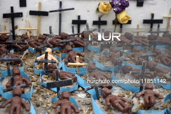 People hold crosses during a demonstration in downtown Sao Paulo, Brazil, on December 9, 2024, to protest against police violence following...