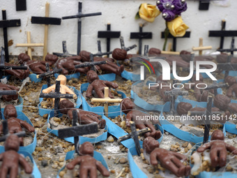 People hold crosses during a demonstration in downtown Sao Paulo, Brazil, on December 9, 2024, to protest against police violence following...