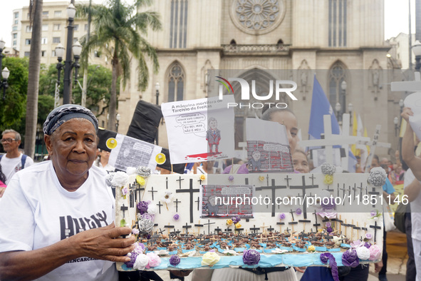 People hold crosses during a demonstration in downtown Sao Paulo, Brazil, on December 9, 2024, to protest against police violence following...