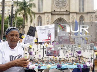 People hold crosses during a demonstration in downtown Sao Paulo, Brazil, on December 9, 2024, to protest against police violence following...