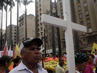 People hold crosses during a demonstration in downtown Sao Paulo, Brazil, on December 9, 2024, to protest against police violence following...