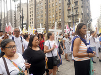 People hold crosses during a demonstration in downtown Sao Paulo, Brazil, on December 9, 2024, to protest against police violence following...