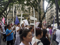 People hold crosses during a demonstration in downtown Sao Paulo, Brazil, on December 9, 2024, to protest against police violence following...