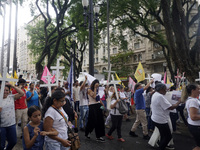 People hold crosses during a demonstration in downtown Sao Paulo, Brazil, on December 9, 2024, to protest against police violence following...