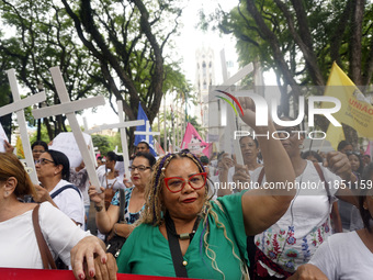 People hold crosses during a demonstration in downtown Sao Paulo, Brazil, on December 9, 2024, to protest against police violence following...