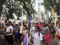 People hold crosses during a demonstration in downtown Sao Paulo, Brazil, on December 9, 2024, to protest against police violence following...