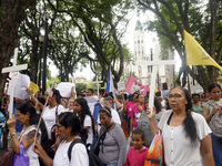 People hold crosses during a demonstration in downtown Sao Paulo, Brazil, on December 9, 2024, to protest against police violence following...