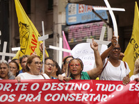 People hold crosses during a demonstration in downtown Sao Paulo, Brazil, on December 9, 2024, to protest against police violence following...