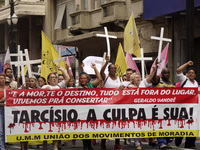 People hold crosses during a demonstration in downtown Sao Paulo, Brazil, on December 9, 2024, to protest against police violence following...