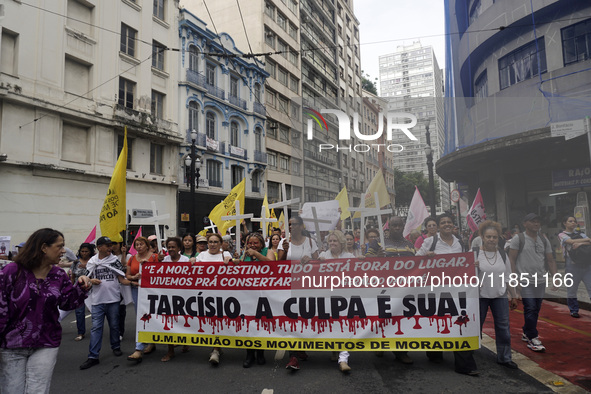 People hold crosses during a demonstration in downtown Sao Paulo, Brazil, on December 9, 2024, to protest against police violence following...