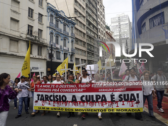 People hold crosses during a demonstration in downtown Sao Paulo, Brazil, on December 9, 2024, to protest against police violence following...