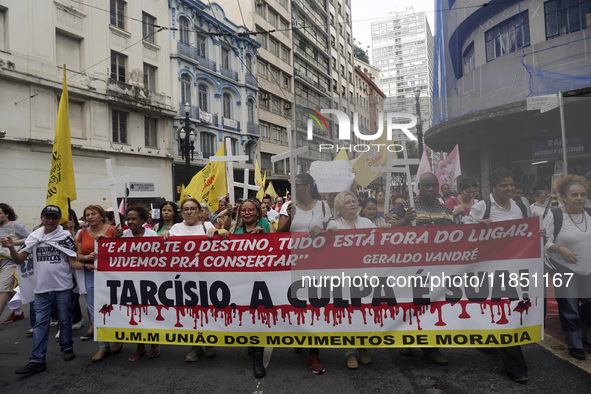 People hold crosses during a demonstration in downtown Sao Paulo, Brazil, on December 9, 2024, to protest against police violence following...