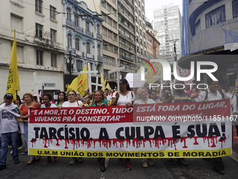 People hold crosses during a demonstration in downtown Sao Paulo, Brazil, on December 9, 2024, to protest against police violence following...