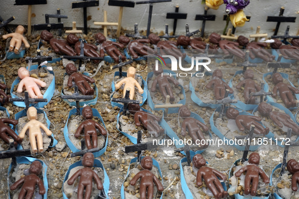 People hold crosses during a demonstration in downtown Sao Paulo, Brazil, on December 9, 2024, to protest against police violence following...