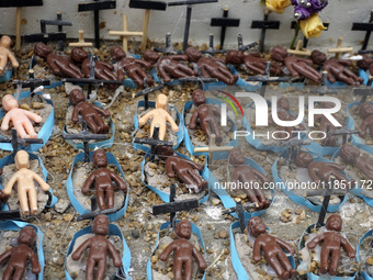 People hold crosses during a demonstration in downtown Sao Paulo, Brazil, on December 9, 2024, to protest against police violence following...