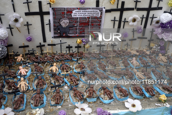 People hold crosses during a demonstration in downtown Sao Paulo, Brazil, on December 9, 2024, to protest against police violence following...