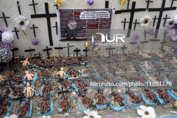 People hold crosses during a demonstration in downtown Sao Paulo, Brazil, on December 9, 2024, to protest against police violence following...