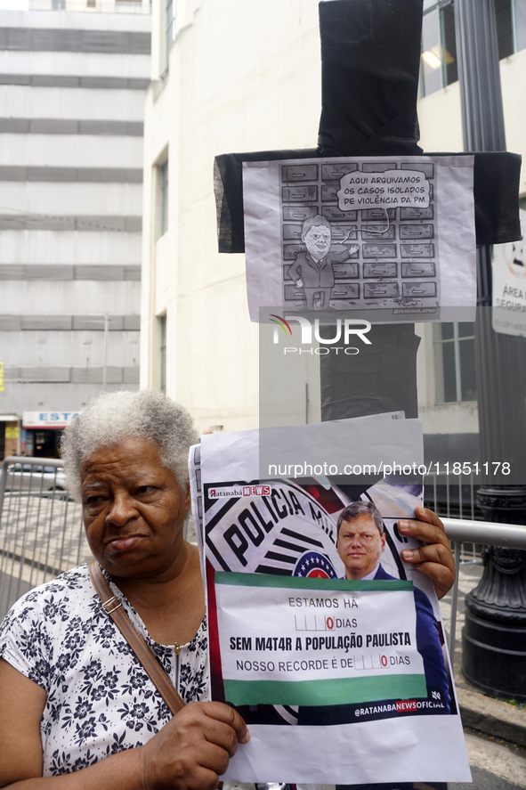 People hold crosses during a demonstration in downtown Sao Paulo, Brazil, on December 9, 2024, to protest against police violence following...