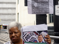 People hold crosses during a demonstration in downtown Sao Paulo, Brazil, on December 9, 2024, to protest against police violence following...