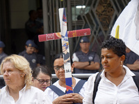 People hold crosses during a demonstration in downtown Sao Paulo, Brazil, on December 9, 2024, to protest against police violence following...