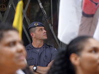 People hold crosses during a demonstration in downtown Sao Paulo, Brazil, on December 9, 2024, to protest against police violence following...