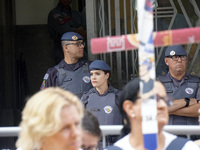 People hold crosses during a demonstration in downtown Sao Paulo, Brazil, on December 9, 2024, to protest against police violence following...