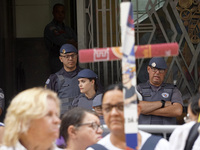 People hold crosses during a demonstration in downtown Sao Paulo, Brazil, on December 9, 2024, to protest against police violence following...