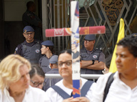 People hold crosses during a demonstration in downtown Sao Paulo, Brazil, on December 9, 2024, to protest against police violence following...