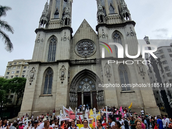 People hold crosses during a demonstration in downtown Sao Paulo, Brazil, on December 9, 2024, to protest against police violence following...