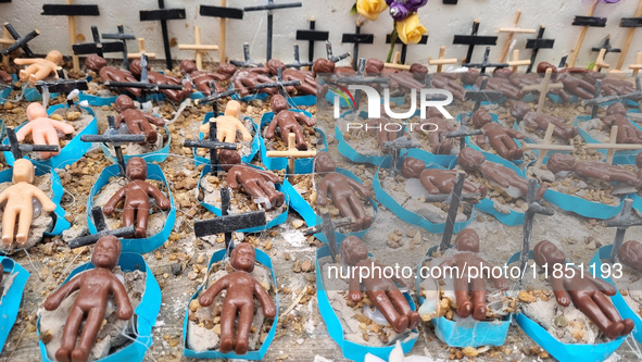 People hold crosses during a demonstration in downtown Sao Paulo, Brazil, on December 9, 2024, to protest against police violence following...