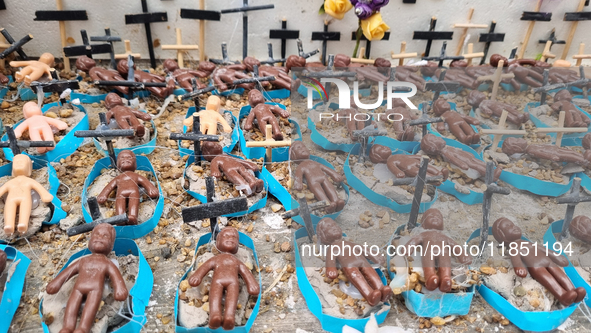 People hold crosses during a demonstration in downtown Sao Paulo, Brazil, on December 9, 2024, to protest against police violence following...